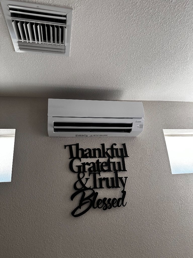 Professional mini split installation on home exterior wall